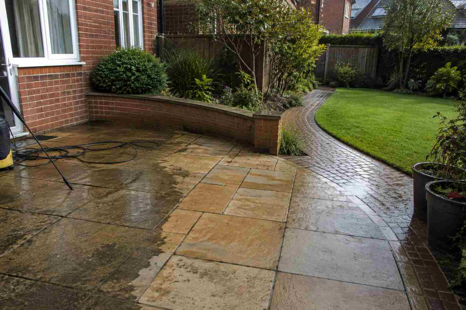 A beautifully landscaped garden with lawn, patio and planted borders in Surrey