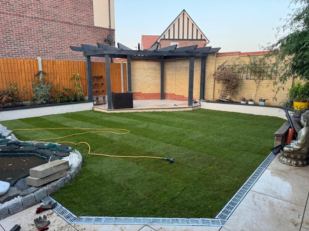 A beautifully landscaped garden with lawn, patio and planted borders in Surrey